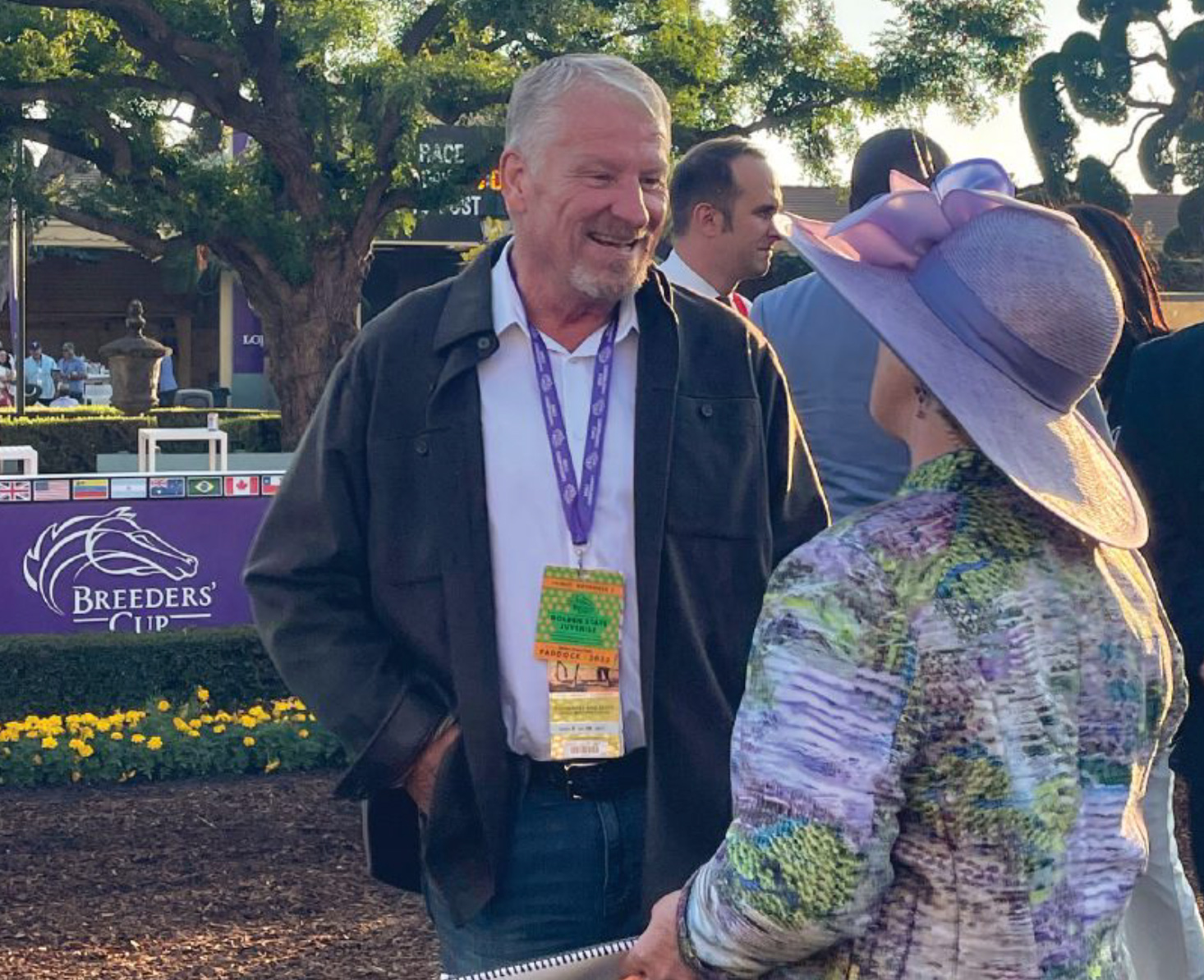 Thomas Hallasz interviewed by a lady in purple hat in a racetrack