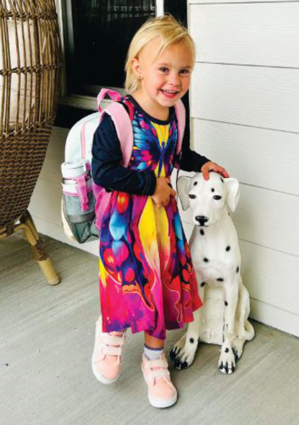 Girl 4 year old, blond, with a dalmatian statue